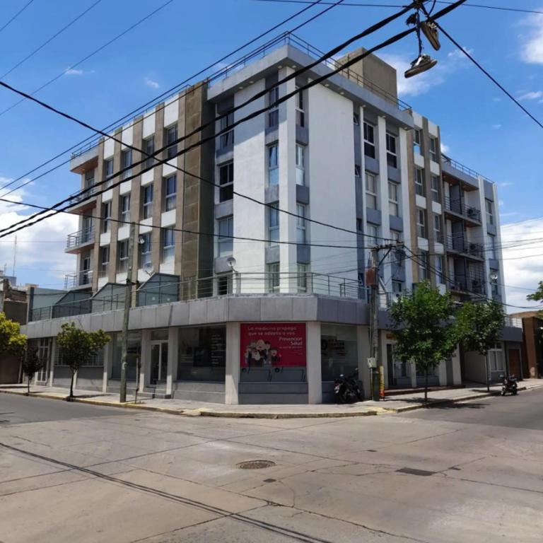 a large white building on a city street at Home Alojamientos Temporales in San Luis