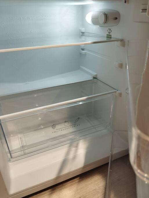 an empty refrigerator with a glass shelf in it at Le Studio de la Seine in Elbeuf