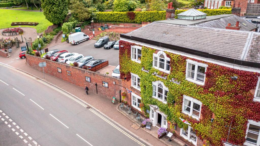 a building covered in ivy next to a street at Mount Pleasant Hotel in Great Malvern