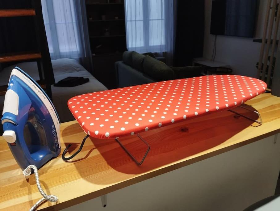 a red pillow with white polka dots sitting on a table at Le Studio de la Seine in Elbeuf