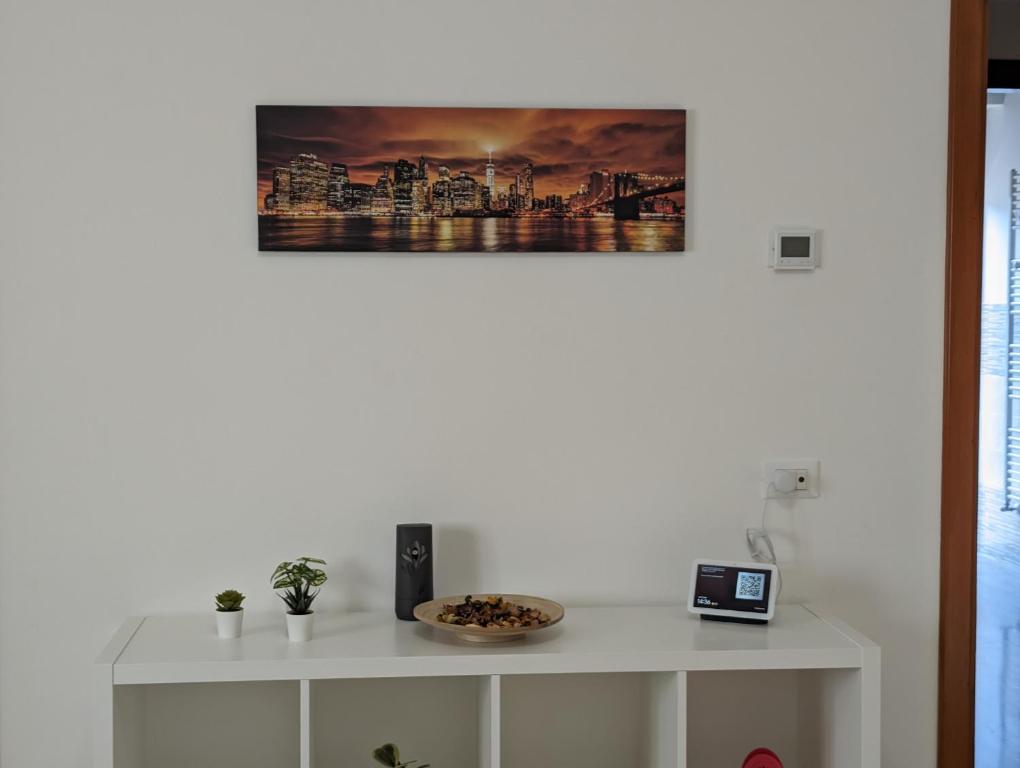 a white cabinet with a picture on the wall at Holiday House 2 in Villamagna