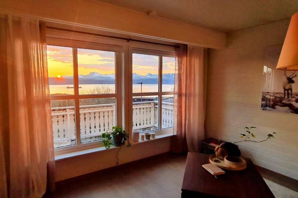 a room with a window with a view of a balcony at Private Mountain House with Spectacular Views in Narvik