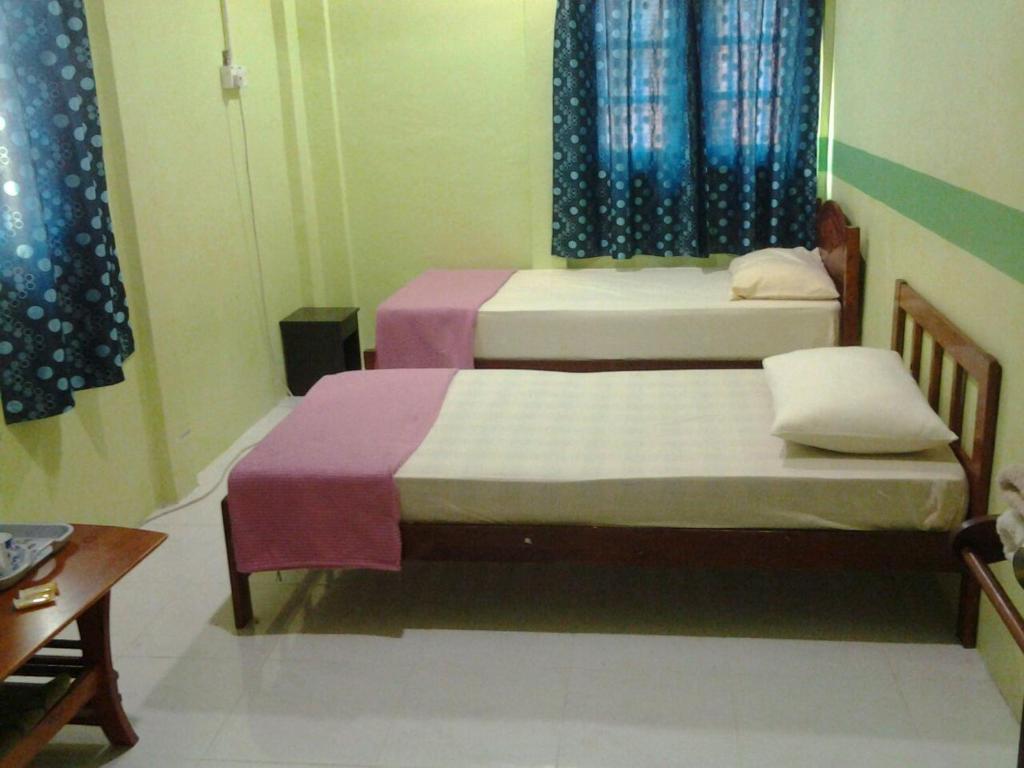 Postel nebo postele na pokoji v ubytování Saba Lodge Dungun