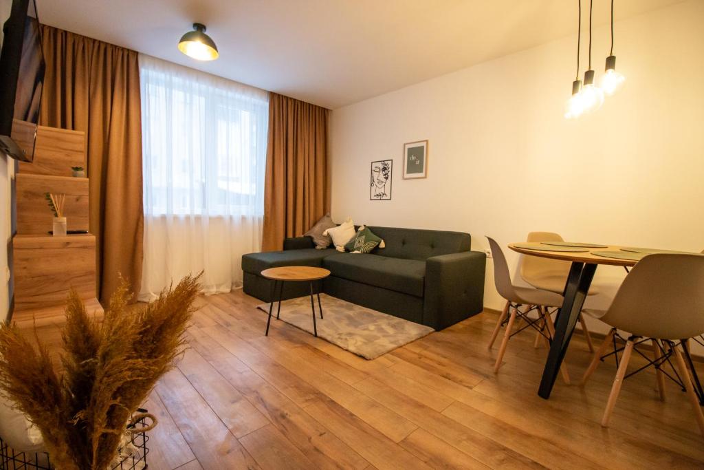 a living room with a couch and a table at MAT Apart in Topliţa