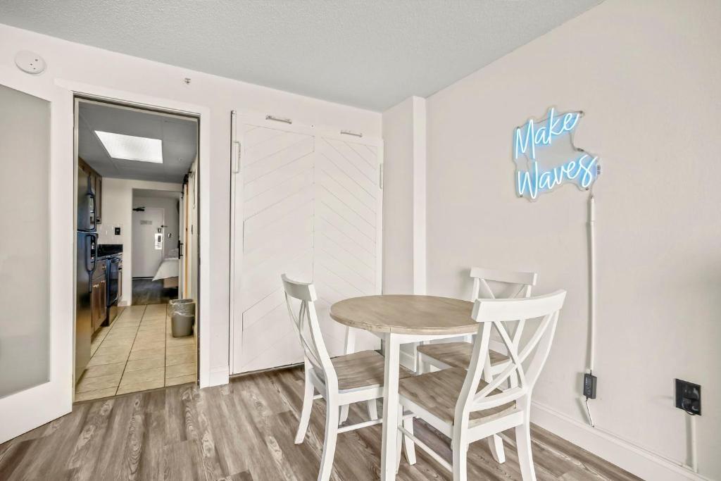 a dining room with a table and two chairs at 441 Landmark Resort in Myrtle Beach