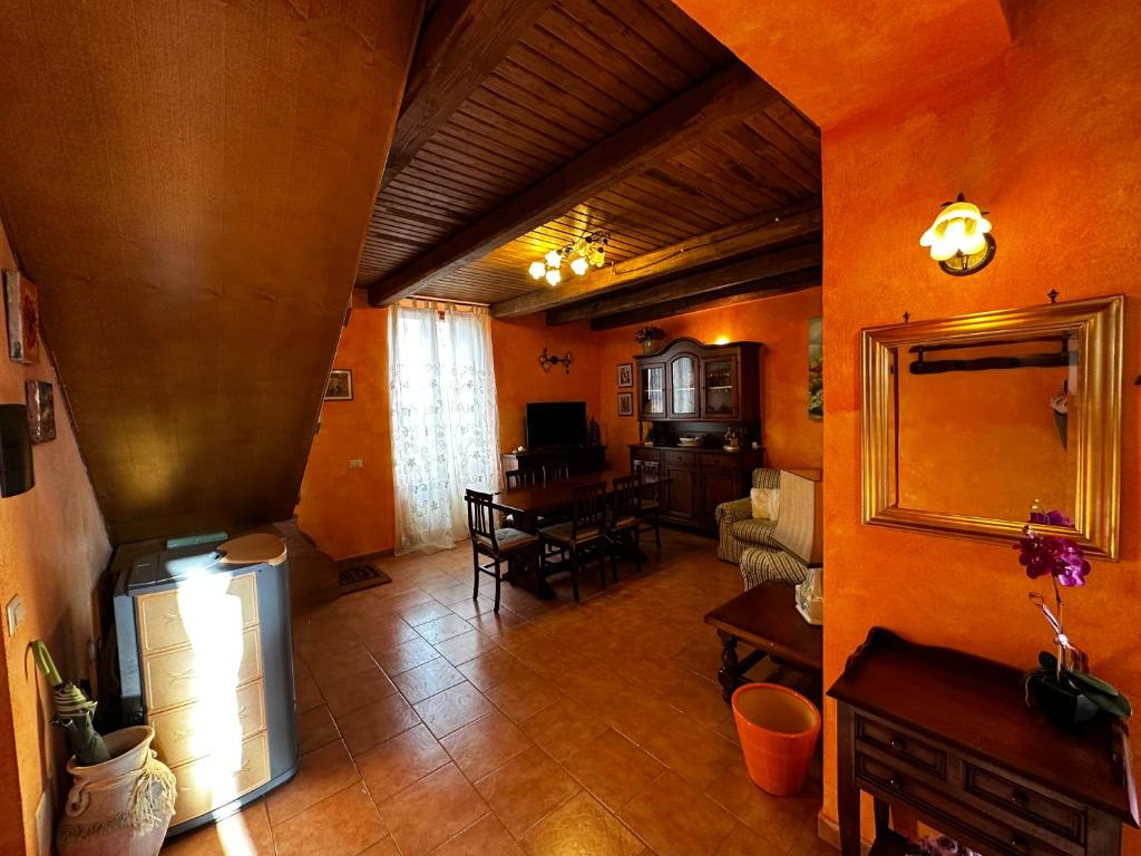a large living room with orange walls and a living room at CASA LORI - Tuscan ToBe in Santa Fiora