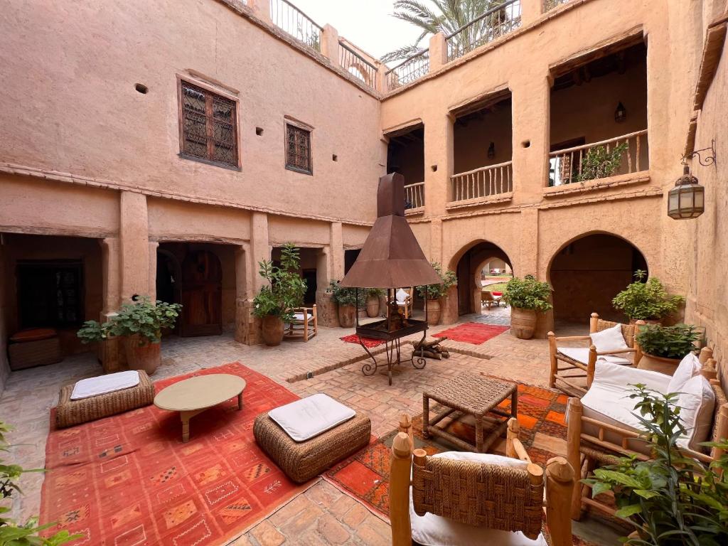 an outdoor patio with furniture in an old building at Dar Les Dattiers in Taroudant