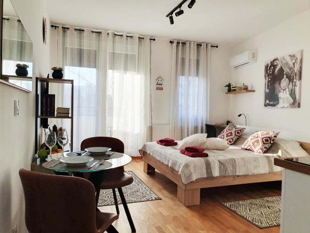 a living room with a couch and a table at APARTMAN 52 - Privatni parking za goste in Novi Sad