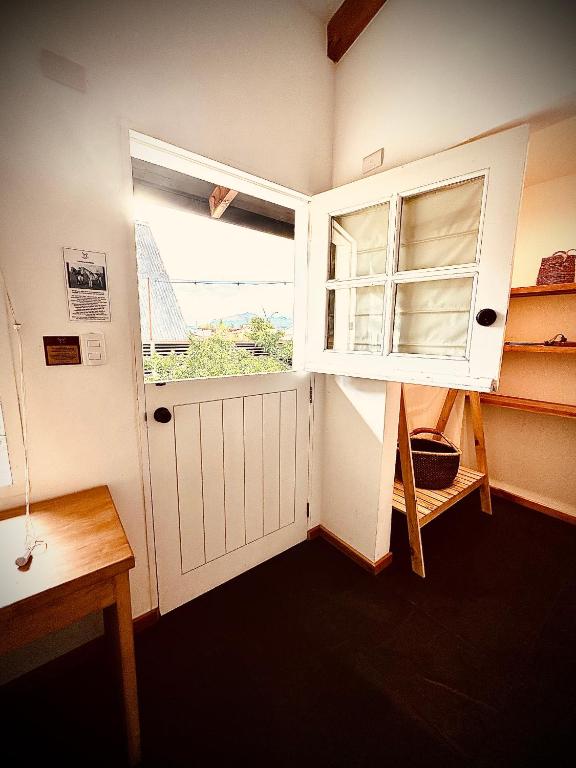 a small room with a door and a window at El Establo in Puerto Natales