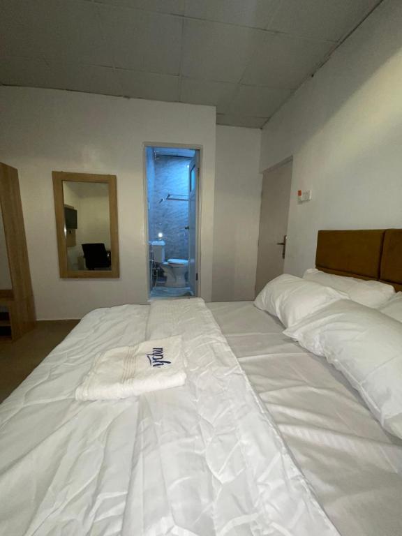 a large white bed with a towel on top of it at Mph 4 in Lagos