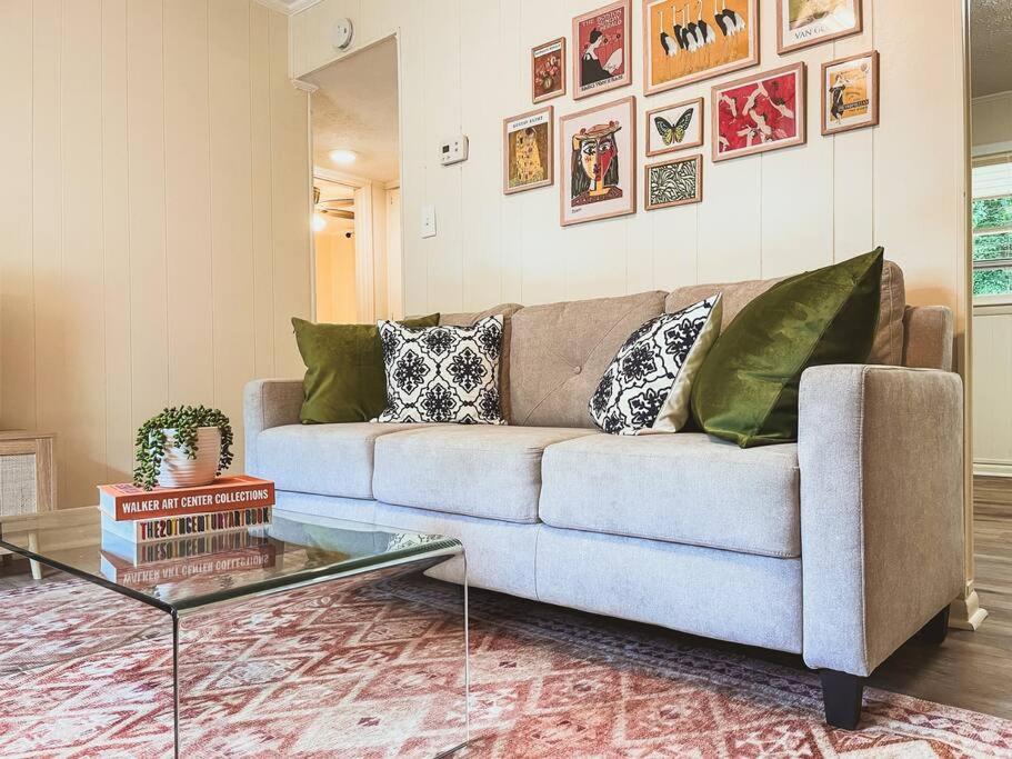 uma sala de estar com um sofá e uma mesa de vidro em Artist's Bungalow - 1/2 mi from Covington Square em Covington