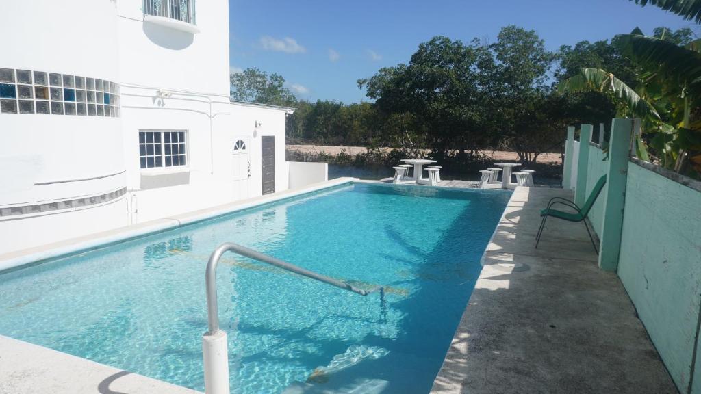una grande piscina blu accanto a un edificio di See Belize WATERSIDE Sea View Suite with Infinity Pool & Overwater Deck a Belize City