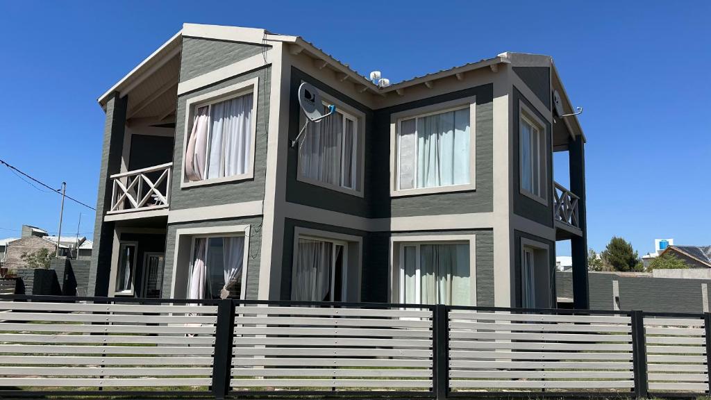 a house with a fence in front of it at Duna zuriak in Playas Doradas