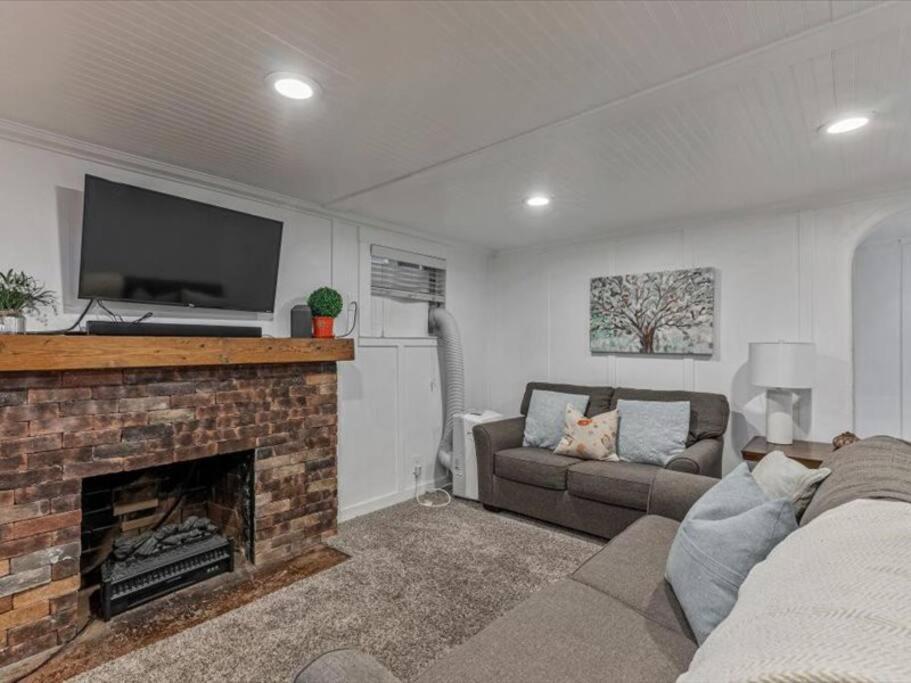 a living room with a fireplace with a flat screen tv at Centrally Located in the Heart of Provo 2 BR in Provo