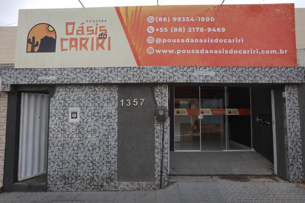 a building with a sign on the front of it at Pousada Oásis do Cariri in Juazeiro do Norte