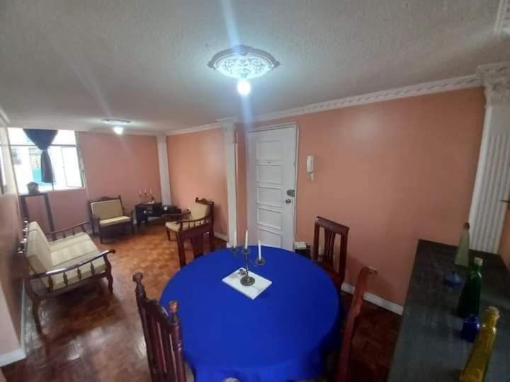 a dining room with a blue table and chairs at Departamento Amoblado en Quito Norte, sector la Udla Universidad Av Granados in Quito