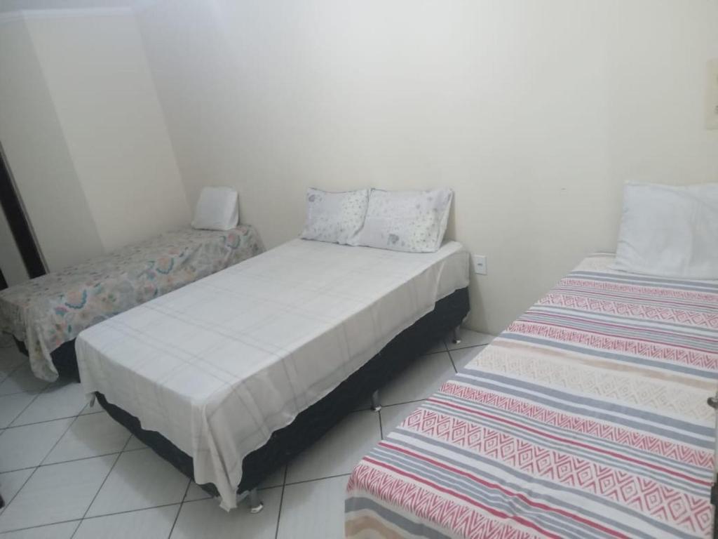 A bed or beds in a room at POUSADA JADY