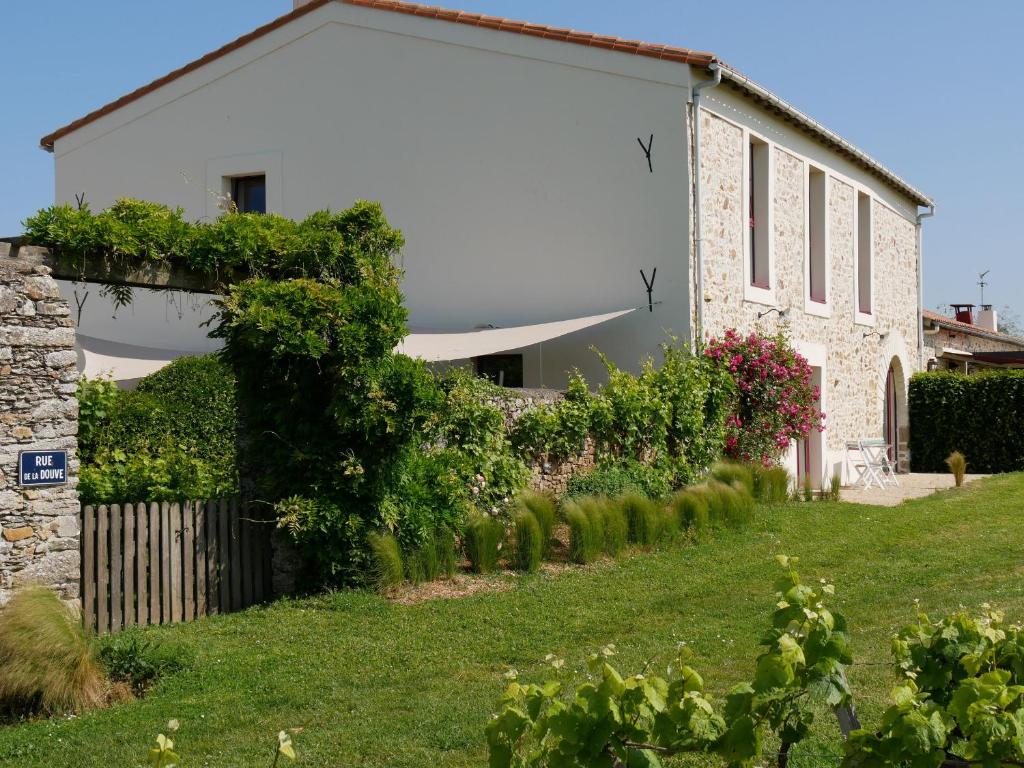 une maison blanche avec un jardin en face dans l'établissement Gîte Château-Thébaud, 3 pièces, 4 personnes - FR-1-306-808, à Châteauthébaud