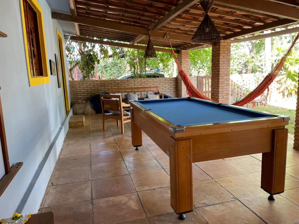 a pool table in the middle of a patio at Casa de Praia em Japaratinga-AL in Japaratinga