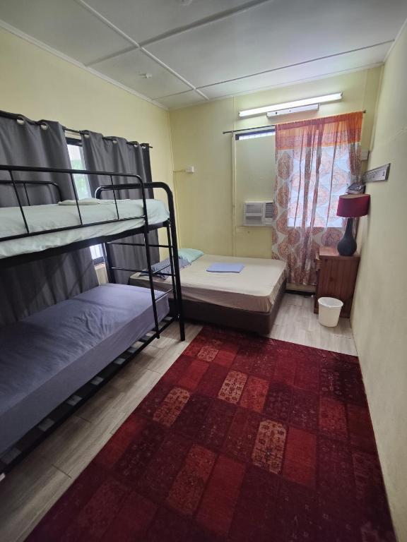 Postel nebo postele na pokoji v ubytování The Cozy Hostel - Motel