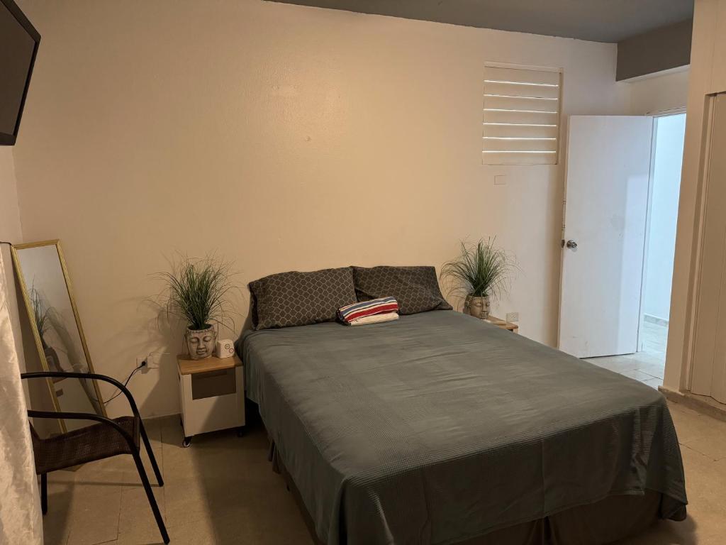 um quarto com uma cama e uma cadeira em 176 Calle Perez (4B2) em San Juan