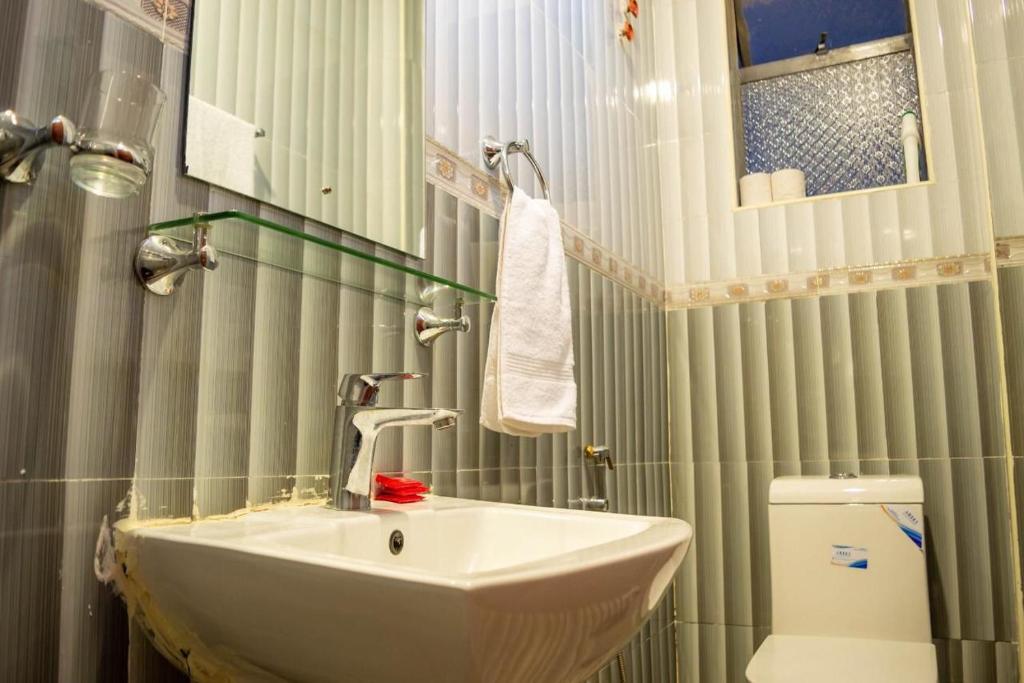 a bathroom with a sink and a toilet at ADRIEL HOMES KIGALi in Kigali