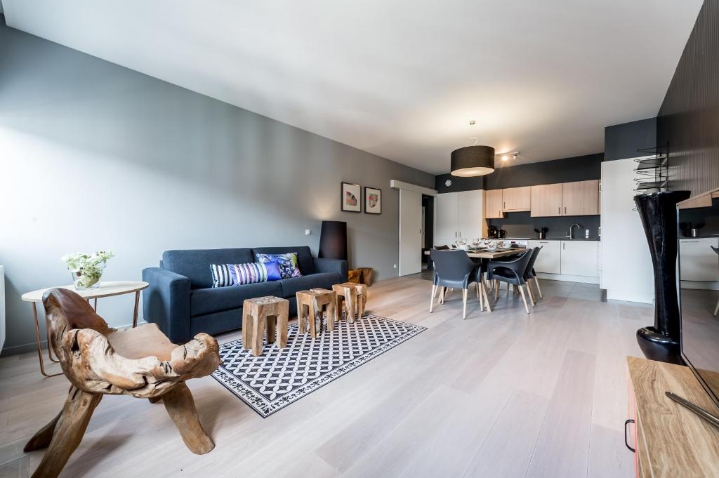 a living room with a couch and a table at Smartflats Design - Cathédrale in Liège