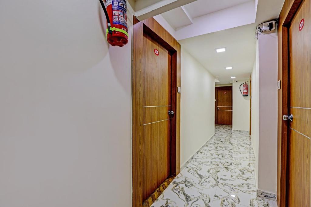a hallway with a door and a floor with a hallway at Collection O Hotel Previliege View in Ahmedabad