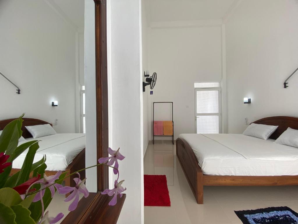 Voodi või voodid majutusasutuse New Sandaru villa toas