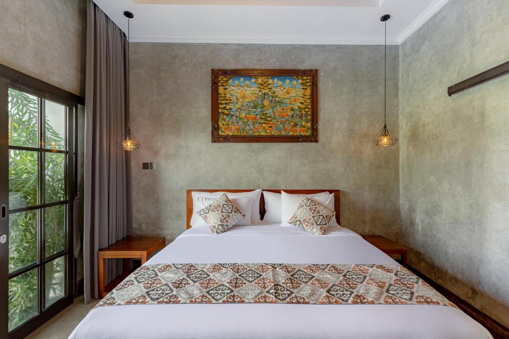 Postel nebo postele na pokoji v ubytování VILLARIZ Ubud , Bali