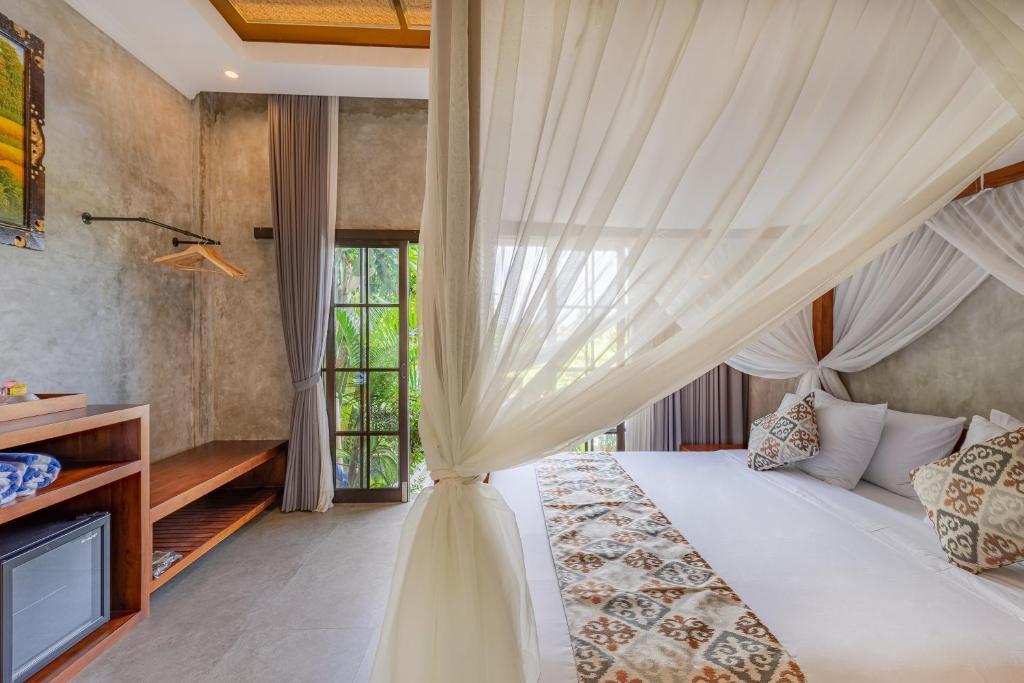 Postel nebo postele na pokoji v ubytování VILLARIZ Ubud , Bali