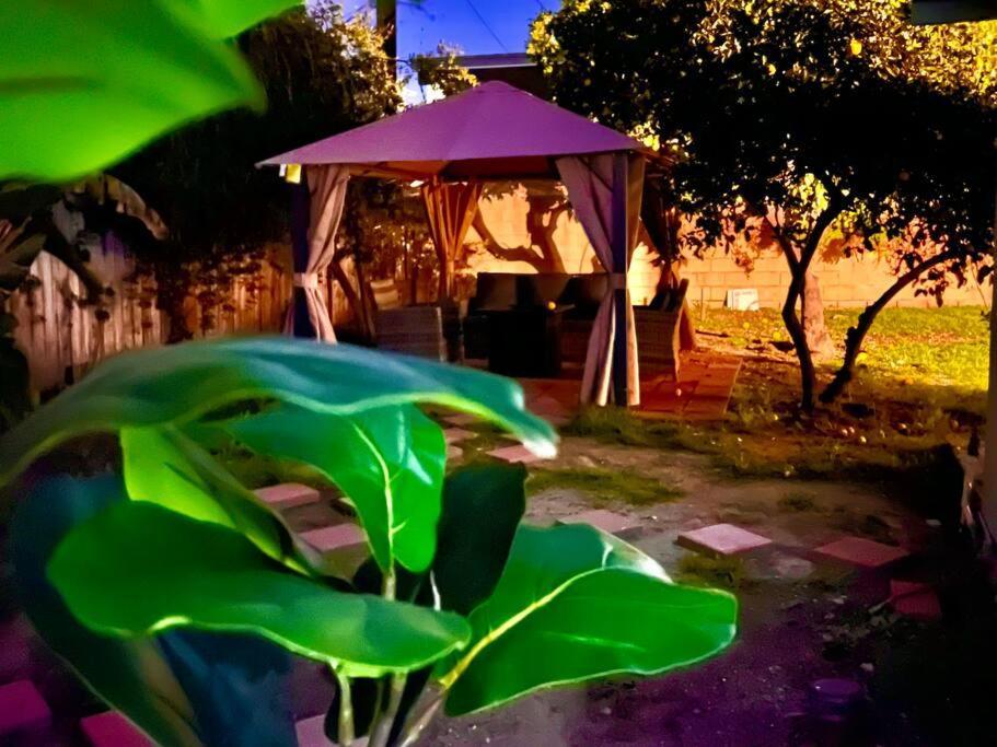 a gazebo with a purple umbrella in a yard at Walk To Americana on Brand. in Glendale