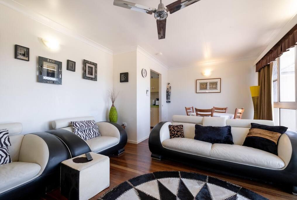 a living room with two couches and a table at Your unit at Southside Central in Bundaberg
