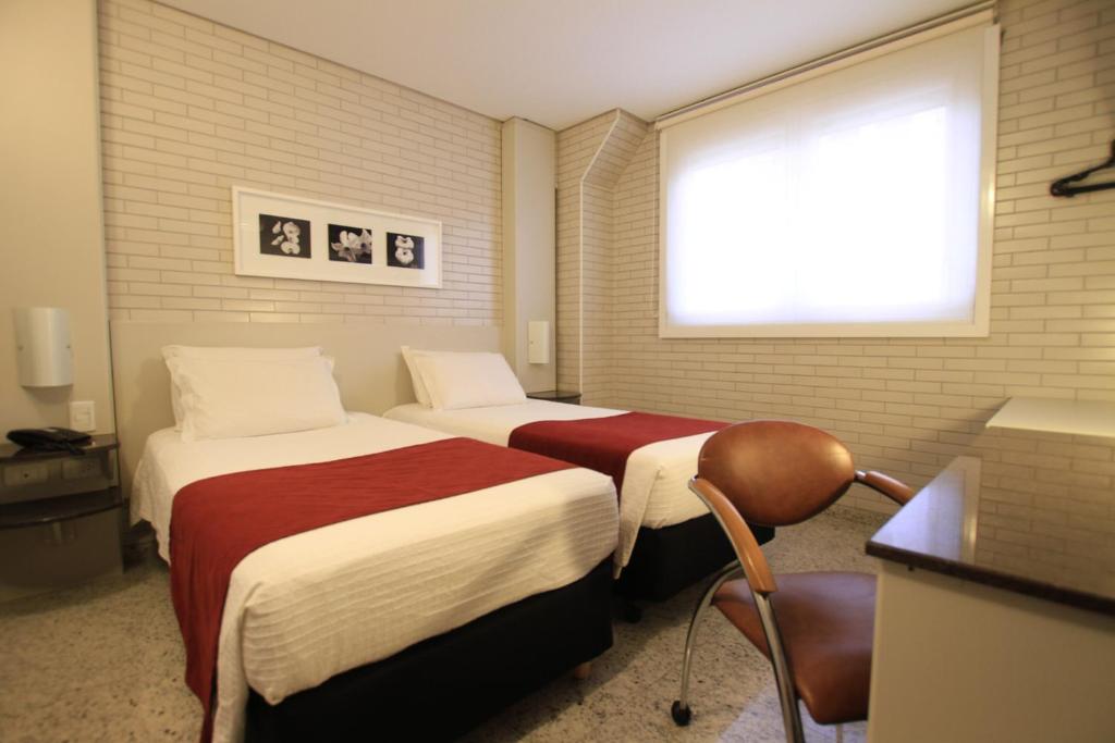 Cama ou camas em um quarto em Hotel Confiance Batel