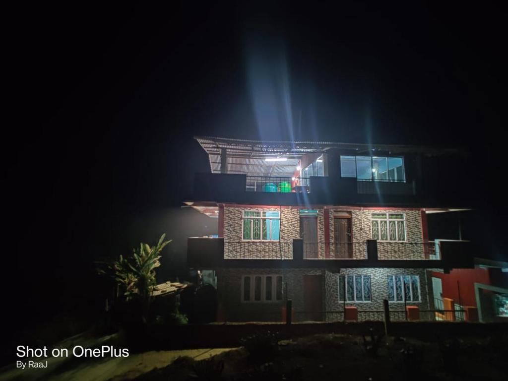 a night view of a building at night at MARYBONG HOME STAY in Darjeeling