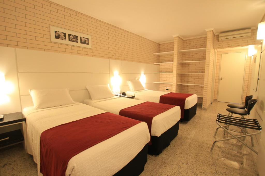 Postel nebo postele na pokoji v ubytování Hotel Confiance Prime Batel
