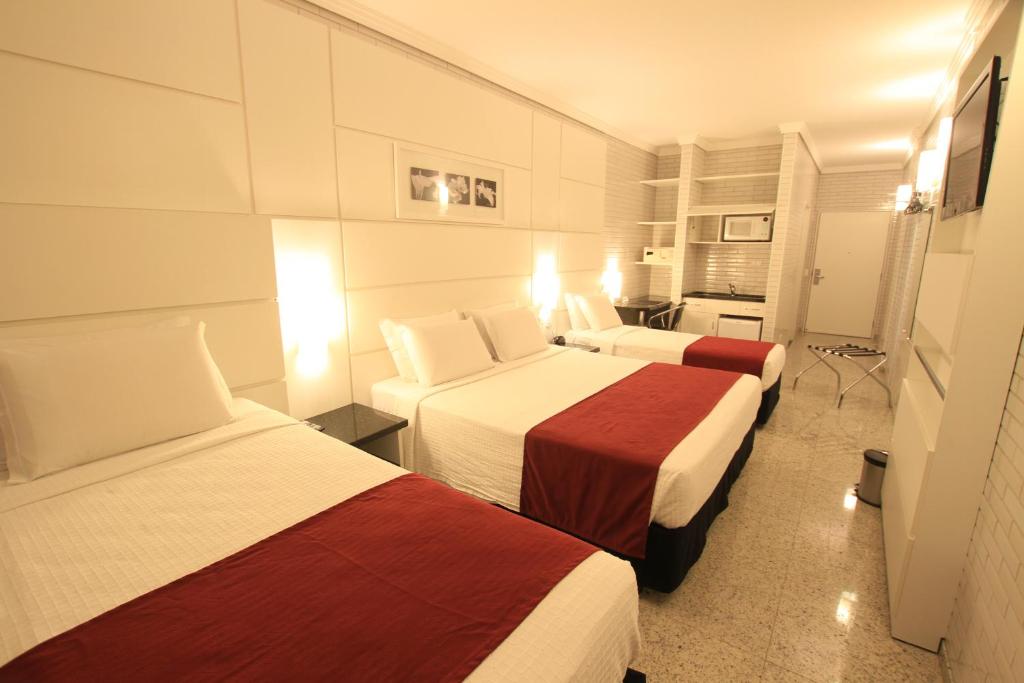 Ένα ή περισσότερα κρεβάτια σε δωμάτιο στο Hotel Confiance Prime Batel