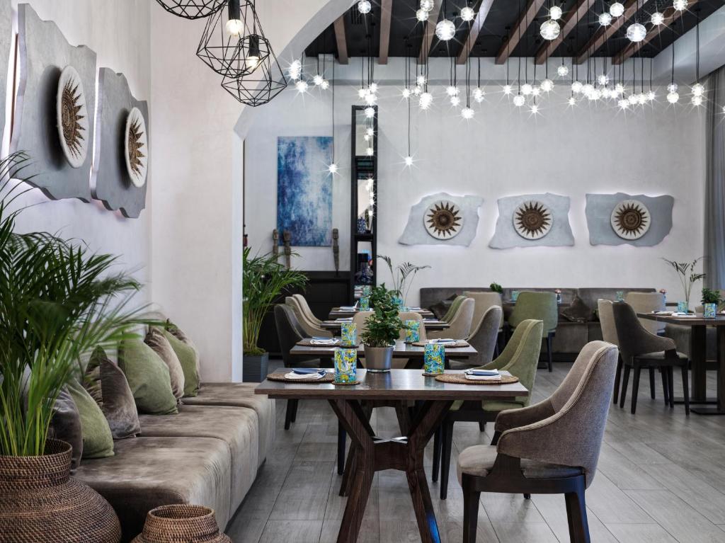 a dining room with a table and chairs at The Chedi Luštica Bay in Tivat