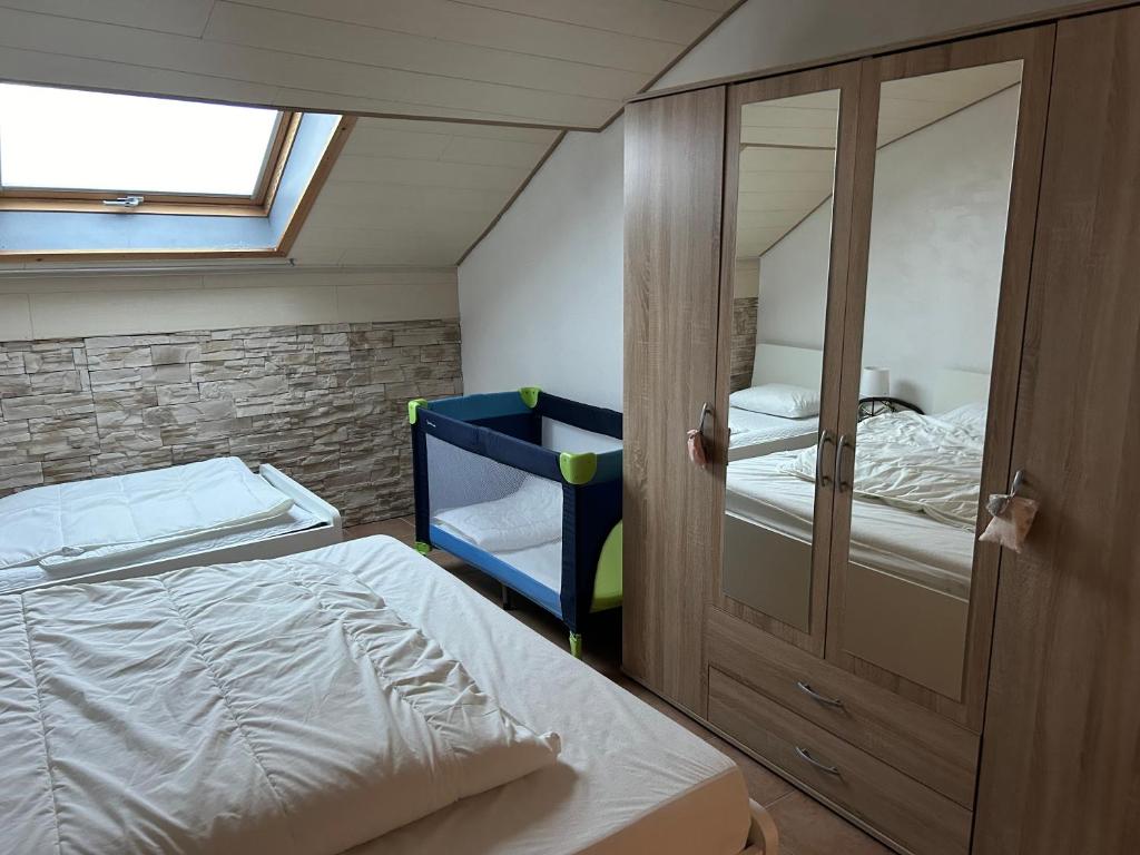 a bedroom with a bunk bed and a mirror at Chez nathalie in Habay-la-Neuve