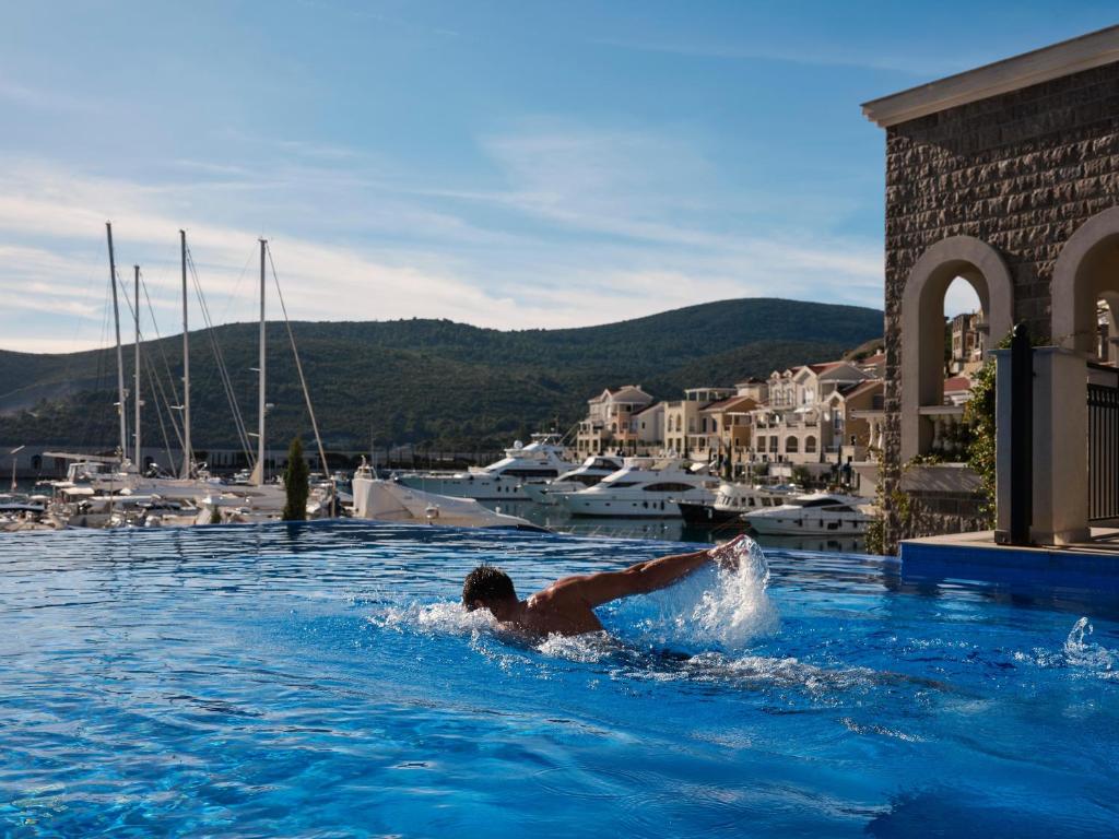 a man in a swimming pool in a marina at The Chedi Luštica Bay in Tivat