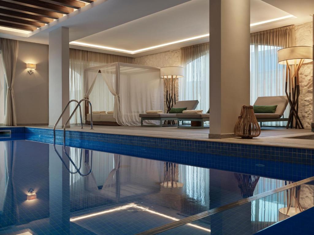 a pool in a hotel room with a hotel suite at The Chedi Luštica Bay in Tivat
