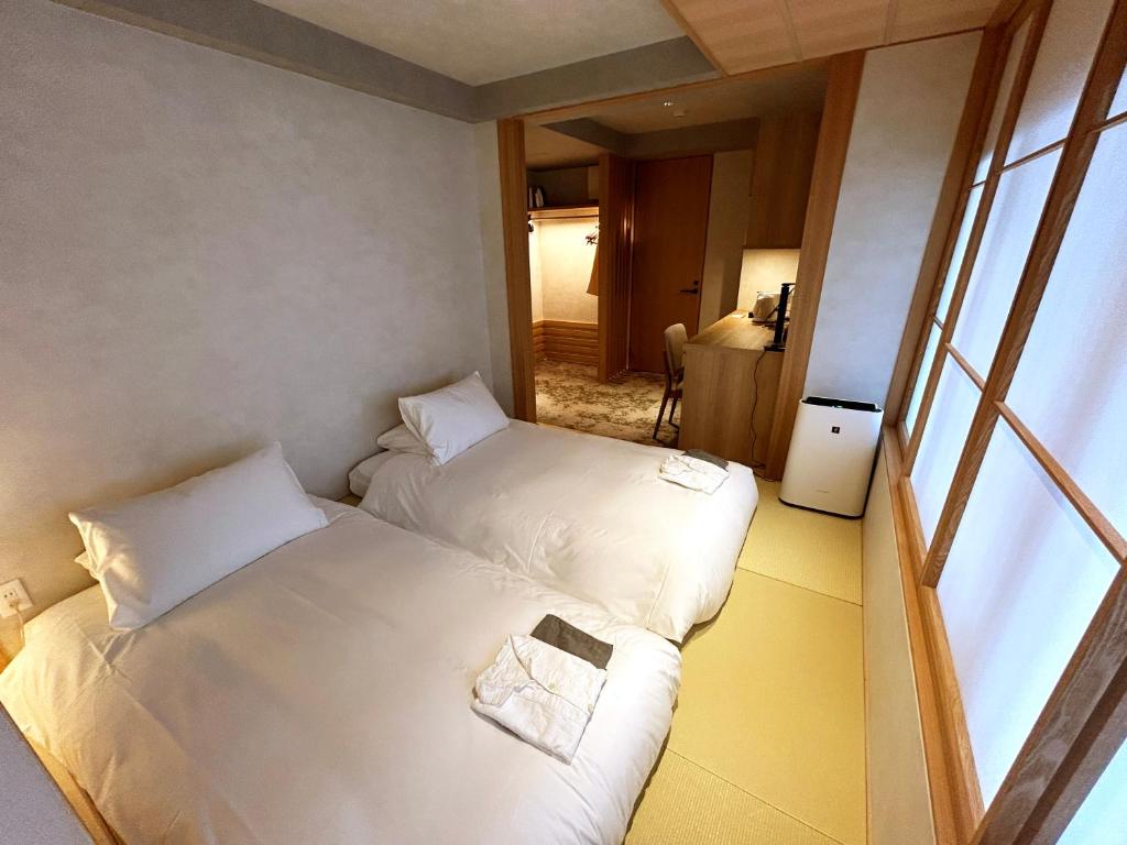 Postel nebo postele na pokoji v ubytování Miru Kyoto Gion