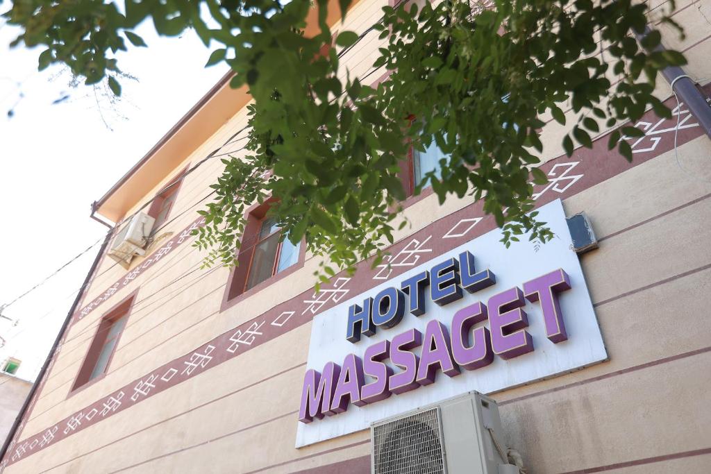 un cartello sul lato di un edificio di MASSAGET HOTEL a Nukus