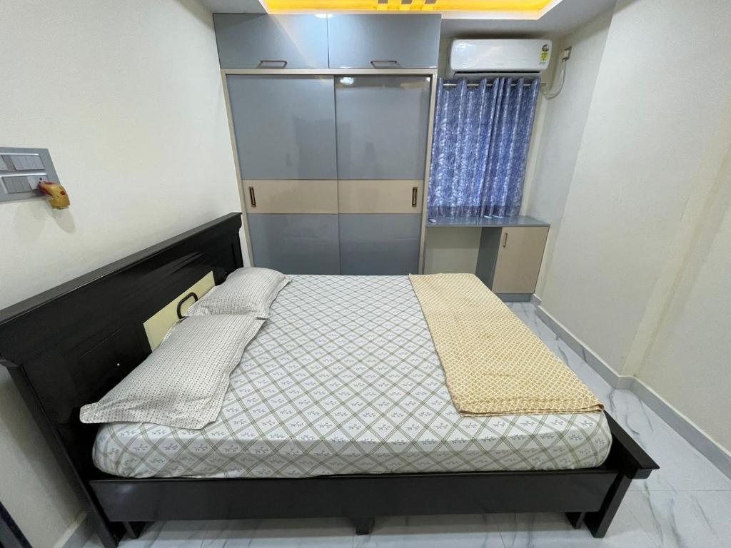 a small bedroom with a bed in a room at Nirvana Home Stay in Visakhapatnam
