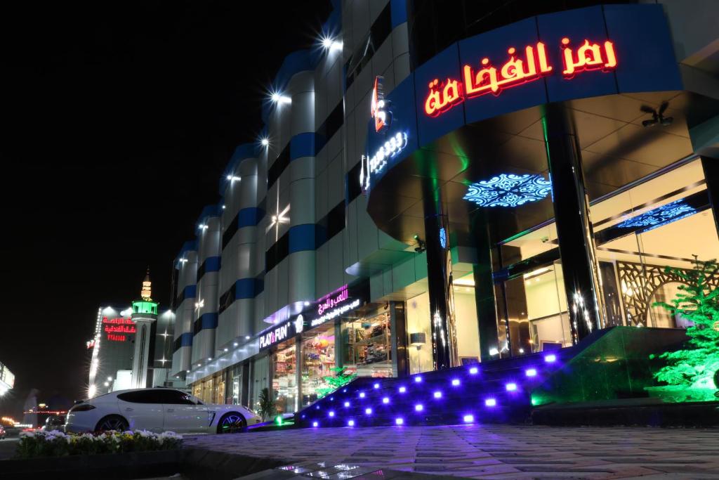 a building with lights in front of it at night at رمز الفخامة in Taif