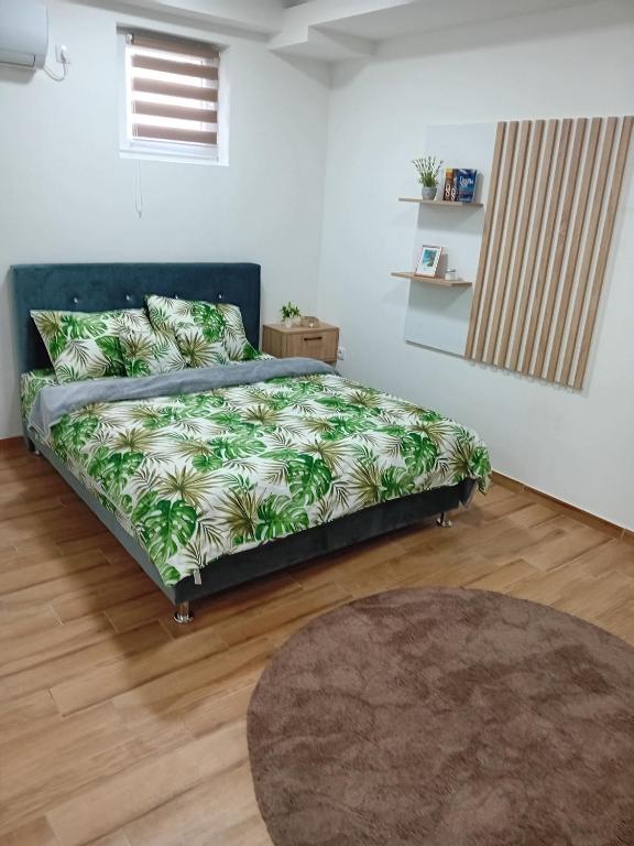 a bedroom with a bed in a room with a rug at Aura Trebinje 2 in Trebinje