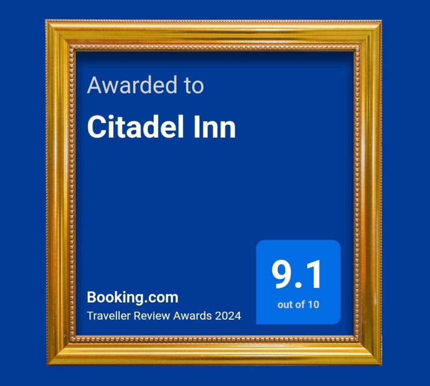 a gold picture frame with the words awarded to circled inn at Citadel Inn in Manila