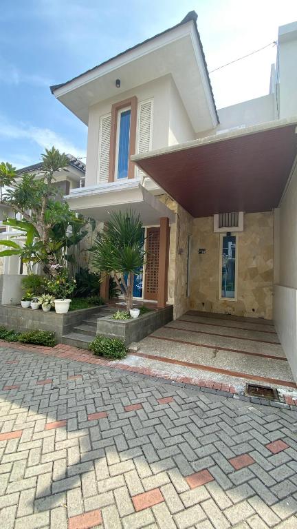 a large white house with a brick driveway at Ghani Villa in Tlekung