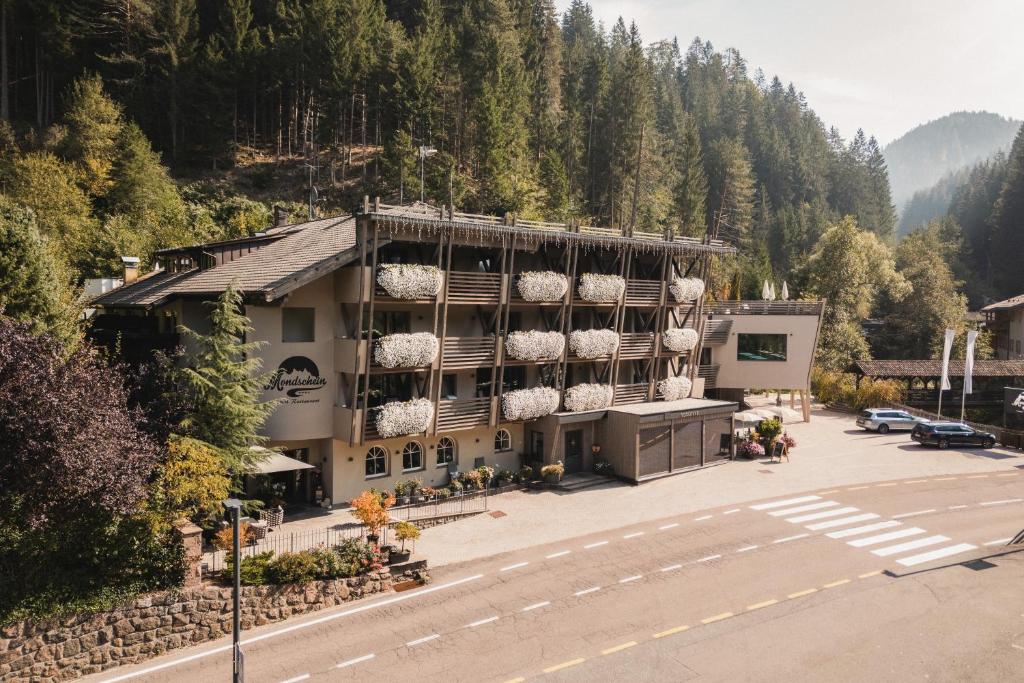 an aerial view of a building with a parking lot at Das Mondschein in Obereggen