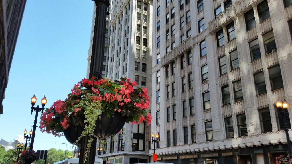 a street light with a flower pot in front of a building at The Chicago Hotel Collection Millennium Park in Chicago